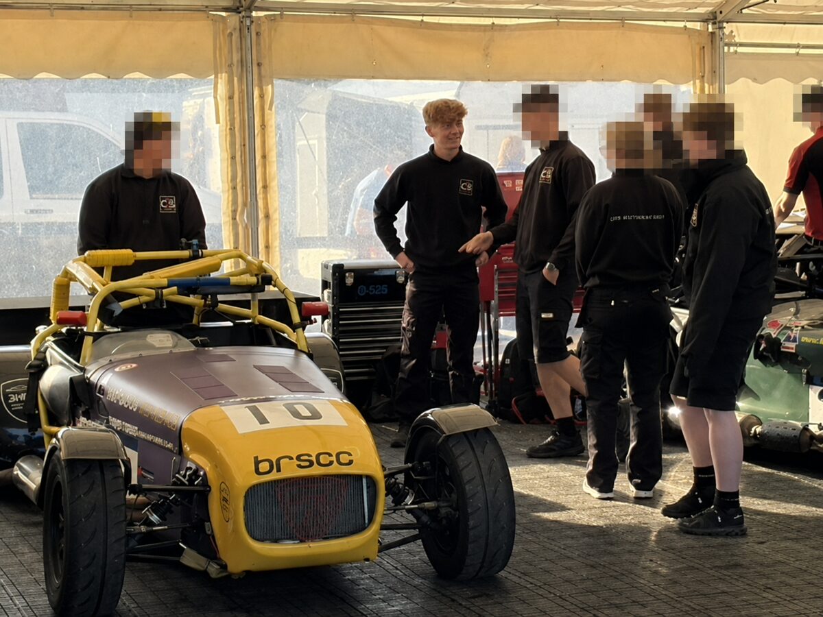 Joshua Worrall with the CTS Motorsport team beside a Caterham race car at Cadwell Park